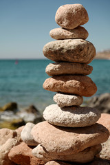 Pyramid of stones for meditation lying on sea coast