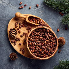 Pine nuts in bowl on gray stone table. Top view.