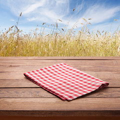 Empty tableclothe on wooden desk. Summer background. Top view mock up. Selective focus.