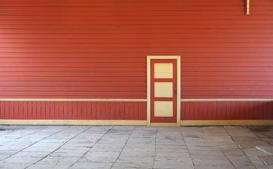 Red wooden wall and closed door (conceptual background for composition)