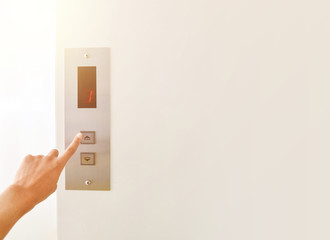 Businessman hand press open button to extend office building elevator doors with copy space  © JAROON