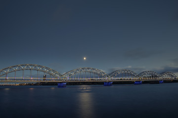 Obraz premium Night view on the illuminated riverside in Riga