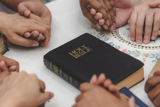 Christian Worship Praying To The Holy Scripture. They Pray Hands Bible In Church For The Faith And Spiritual Concept Of Religion.