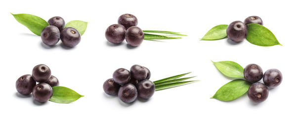 Set with acai berries and green leaves on white background. Organic superfood