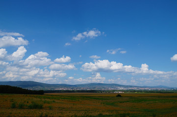A vast landscape with sky covered with whirling clouds. Pecs city in the south of Hungary.