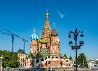 Spasskaya Tower against blue sky with white clouds. Kremlin.