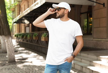 Young man wearing white t-shirt on street