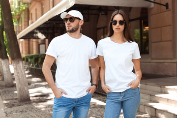 Young couple wearing white t-shirts on street