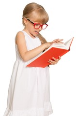 Little Girl Standing with Glasses and Reading Book - Isolated
