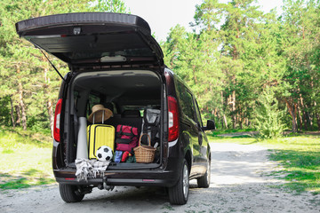 Van with camping equipment in trunk outdoors © New Africa