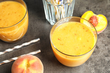 Tasty peach smoothie on table. Healthy drink