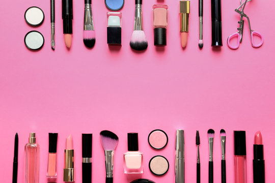 Flat lay composition with products for decorative makeup on pink background