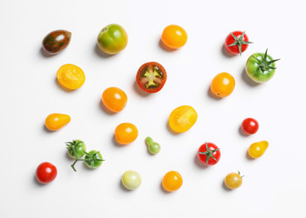 Flat lay composition with different tasty tomatoes on white background