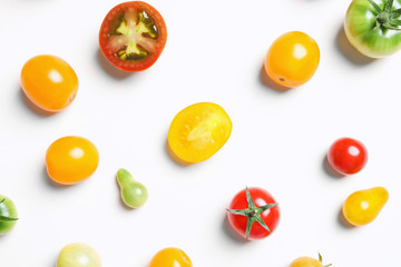 Flat lay composition with different tasty tomatoes on white background