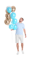 Young man with air balloons on white background