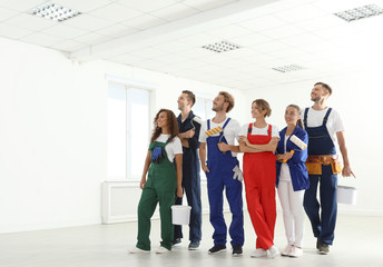 Team of professional painters with tools working indoors