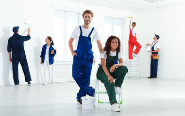 Fototapeta premium Team of professional painters with tools working indoors