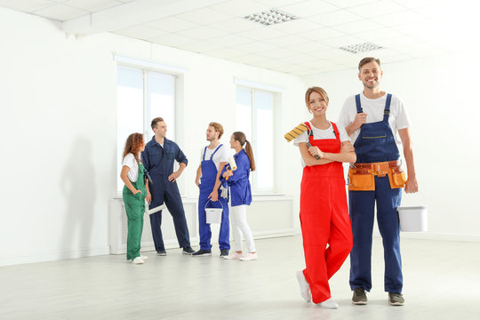 Team of professional painters with tools working indoors