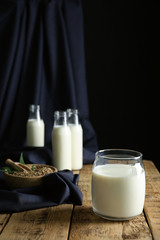 Jar of hemp milk on wooden table