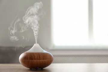 Modern aroma lamp on table against blurred background with space for text - obrazy, fototapety, plakaty