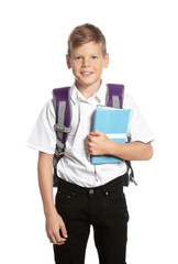 Cute boy with school stationery on white background