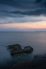 Fototapeta premium Sunset colors reflecting on the sea at Fanari beach, Komotini, Greece