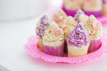 pink cupcake on the table. White background.