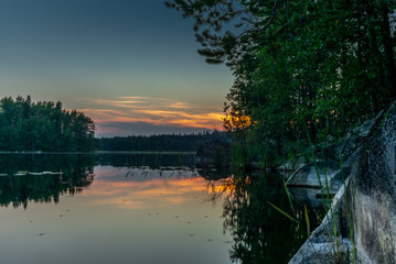 Sunset on the shores of the calm Saimaa lake in the Kolovesi National Park in Finland - 11