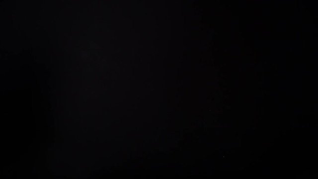 one potato chips in free fall on a black background. Slow motion. The view from the side. Pringles