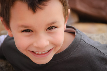 Portrait of smiling white boy looking up