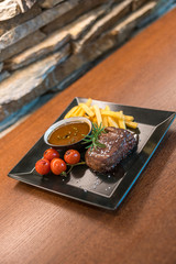 Fototapeta na wymiar Steak with french fries on wooden table