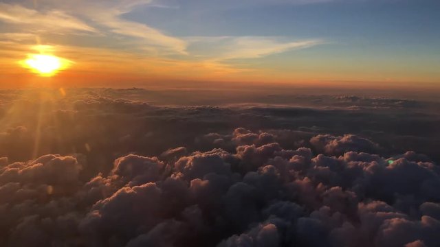Sunset above the clouds flying away from Phuket Thailand
