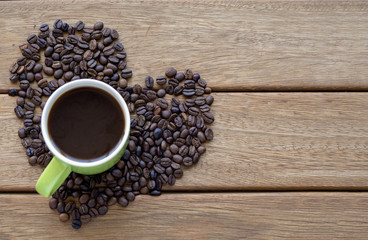 a cup of coffee over the yellow ground and coffee beans
