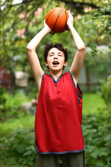 teenager basketball palyer training with ball