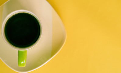 a cup of coffee over the yellow ground