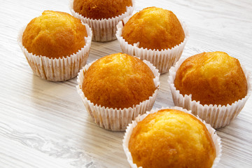 Fresh muffins on a white wooden table, side view. Close-up.