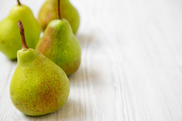 Tasty pears on a white wooden background, side view. Close-up. Copy space.