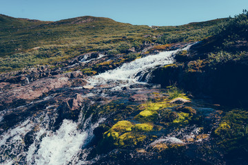 Waterfall landscape on the mountain slope in Norwegian highlands