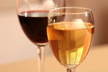 A glass of white wine and a glass of red wine