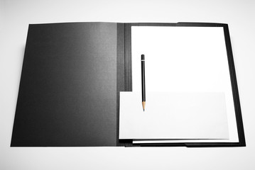 Folder, blank sheets of paper, envelope, and pencil