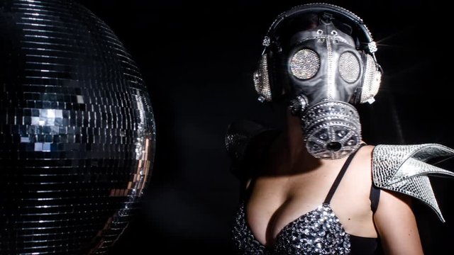 amazing woman dancing in diamond covered gas mask and costume