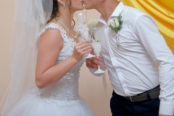 The two newlyweds keep champagne and kissing.