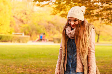 Smiling woman relaxing outdoor in autumnal park