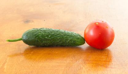 fresh tomato and cucumber on a brown table