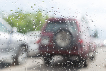 Car windshield in traffic jam during rain