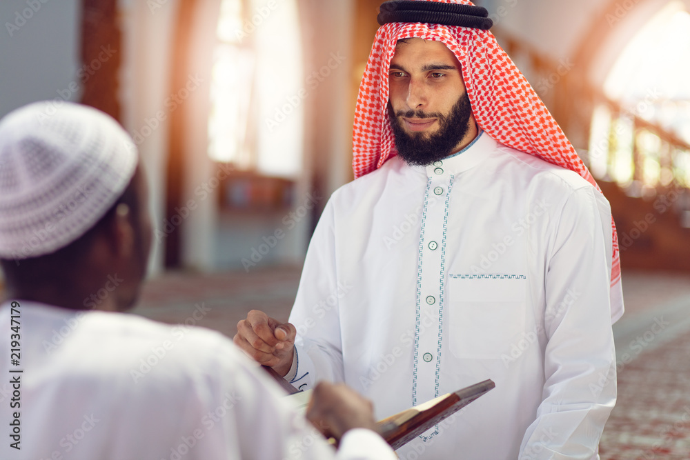 Poster Two religious muslim man praying together inside the mosque