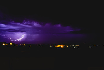 Rays in a night storm with light and clouds.