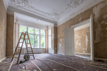 renovation concept - ladder in empty  apartment room during restoration or refurbishment