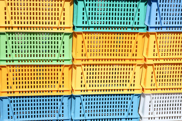 Texture from colored plastic colored yellow blue green rectangular boxes with holes for goods,...