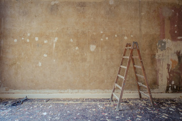 ladder in old apartment during renovation - home decoration, restoration concept